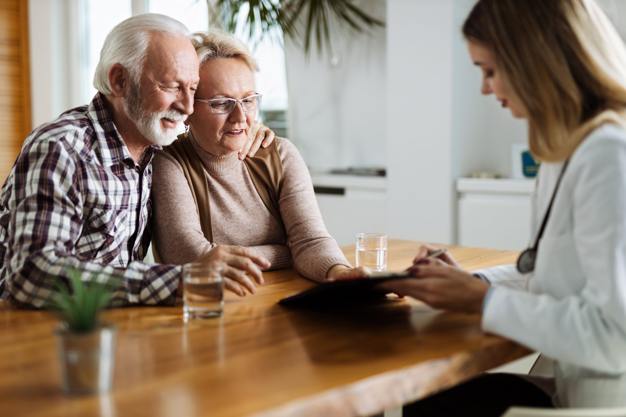 Elderly couple consulting with a doctor.