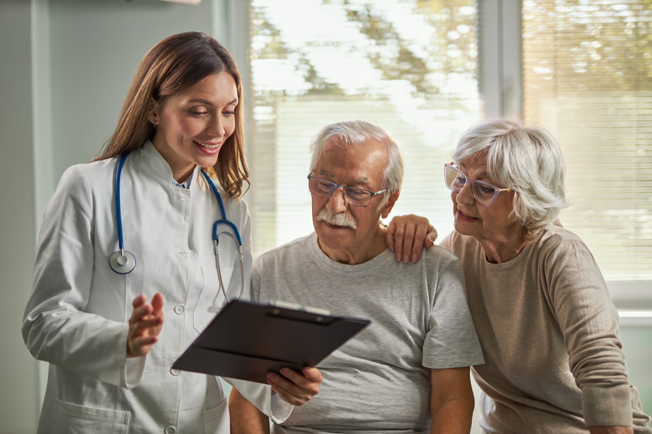 Doctor discussing results with elderly couple.