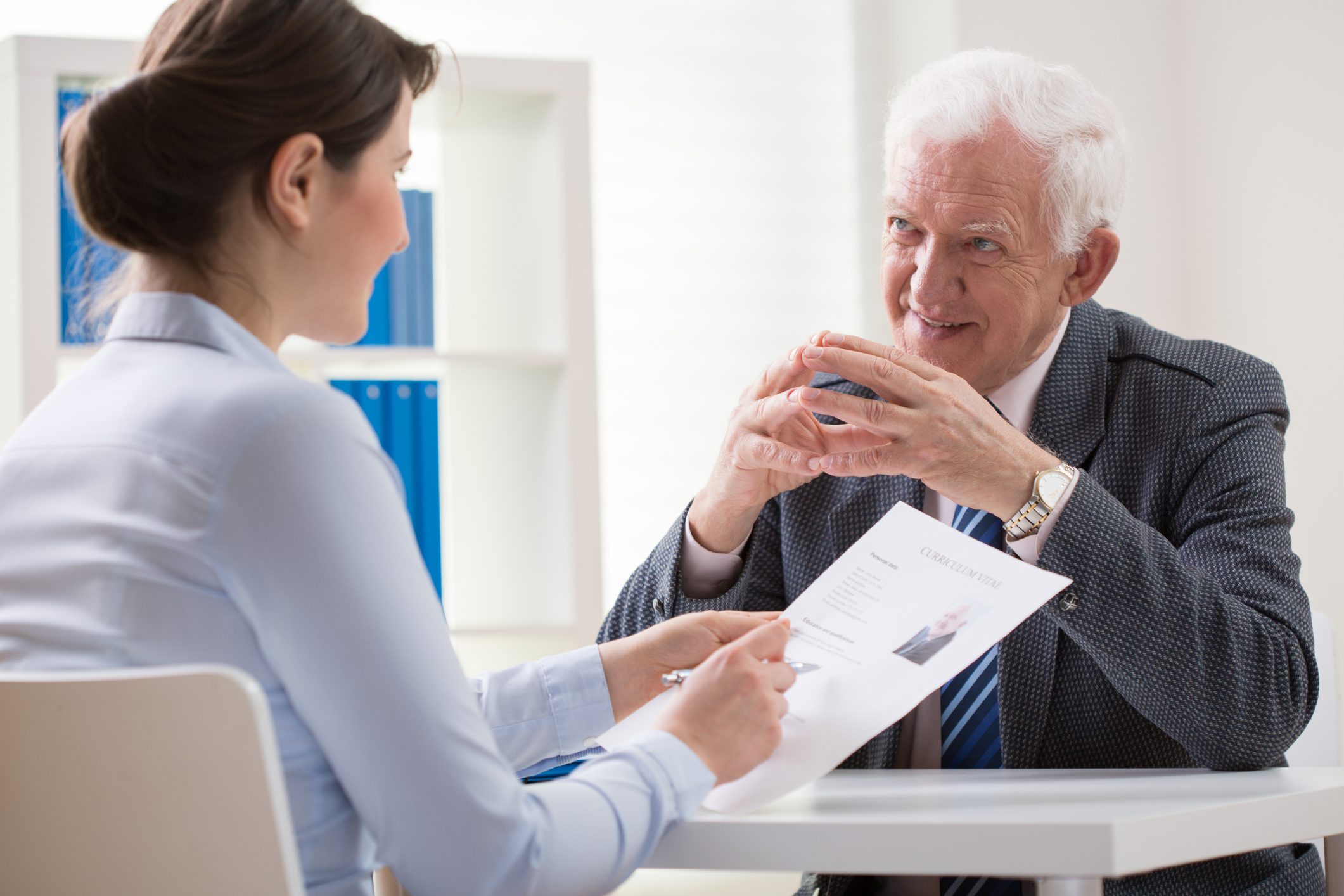 Two people discussing over a document.
